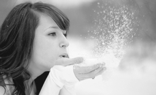 blowing snow off her hands